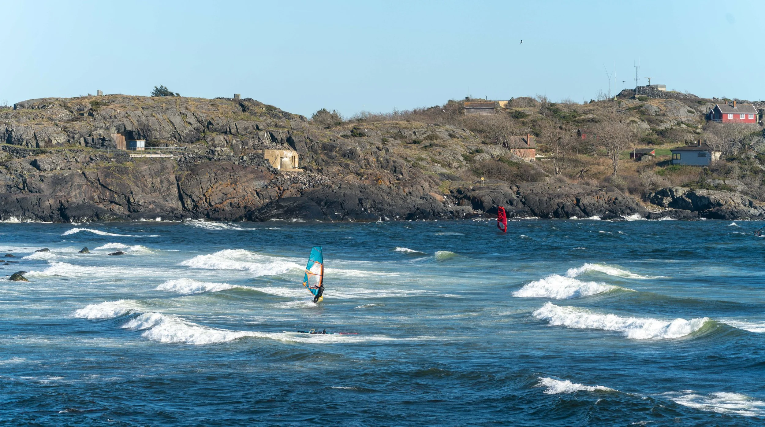 Dynamic windsurfing captured in strong coastal waves at Saltstein beach. A powerful moment of balance, motion, and energy in Scandinavian surf conditions.