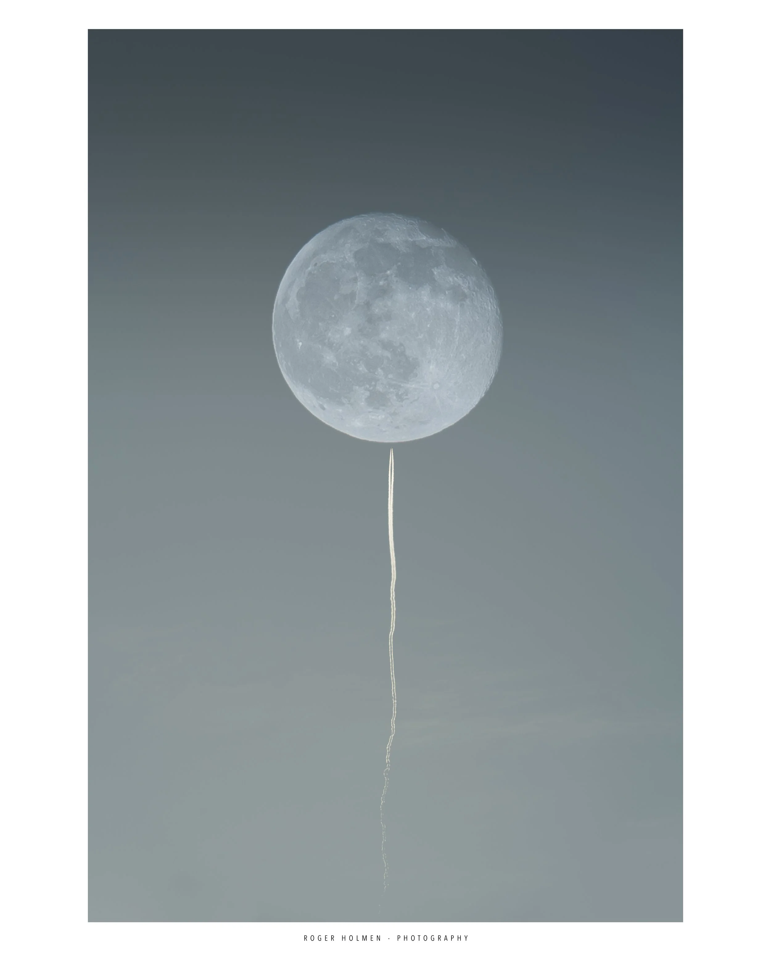 Moon in the sky with a string hanging below it, resembling a balloon.