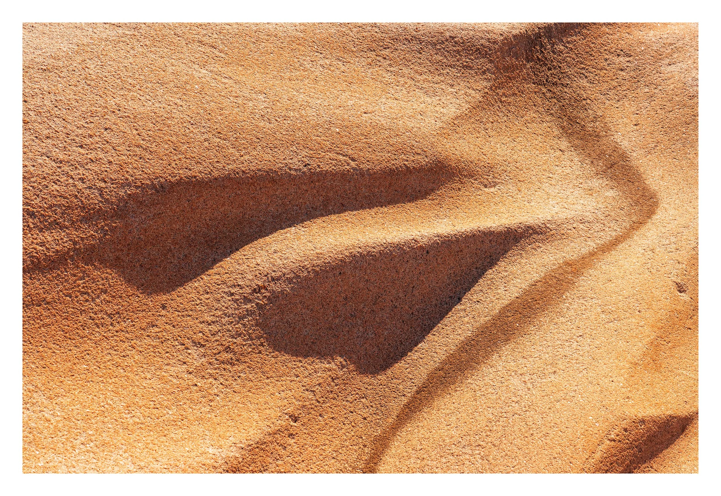 Sculpted by Time V Abstract detail of warm Bohus granite where strong sunlight and deep shadow create graphic natural forms.