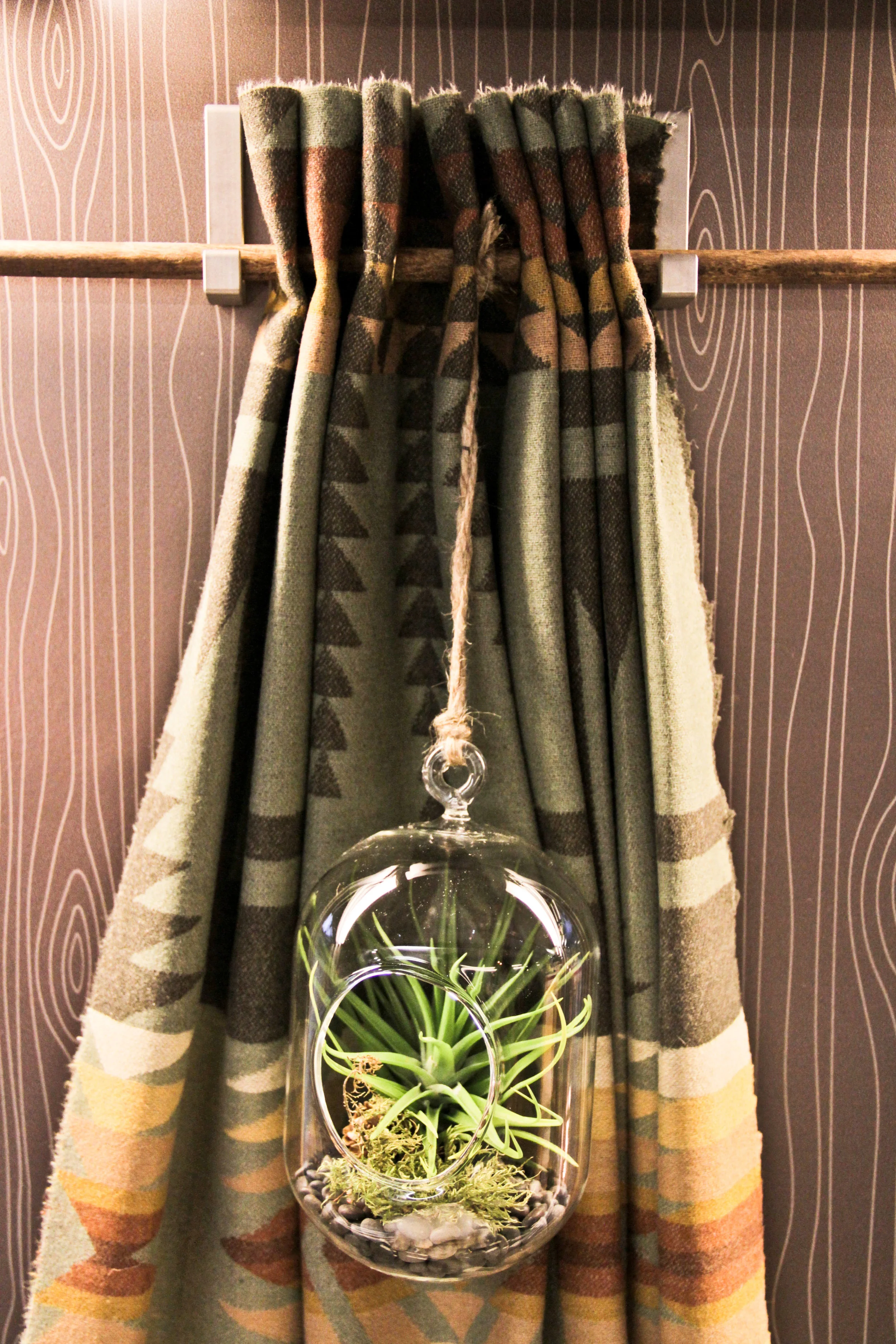 I handmade these curtains by adding brass grommets and staining the dowels.
