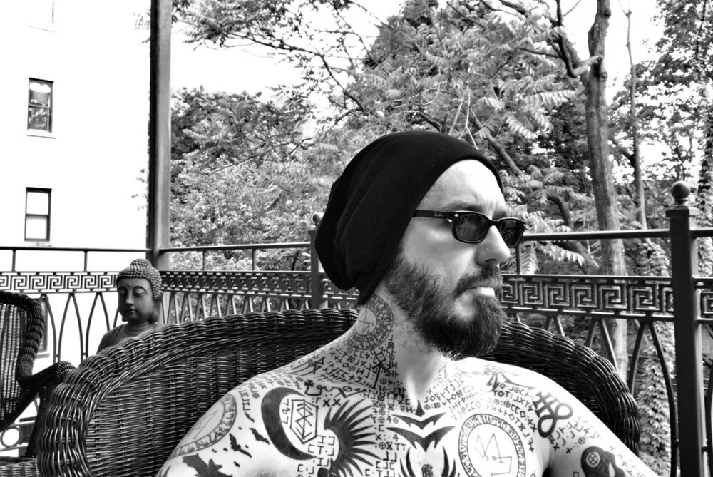 Damien-tattoos-porch-buddha_credit-LorriDavis-2018-1068x714.jpg