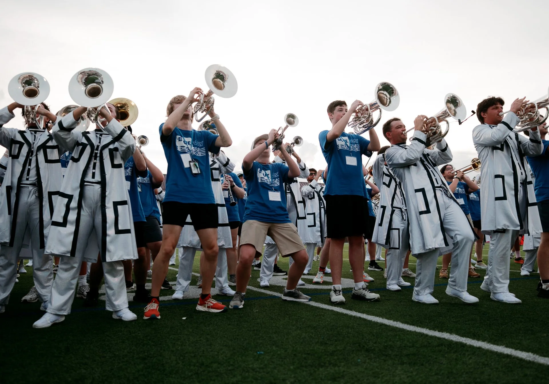Photo of The Blue Way participants playing next to the Bluecoats performers.