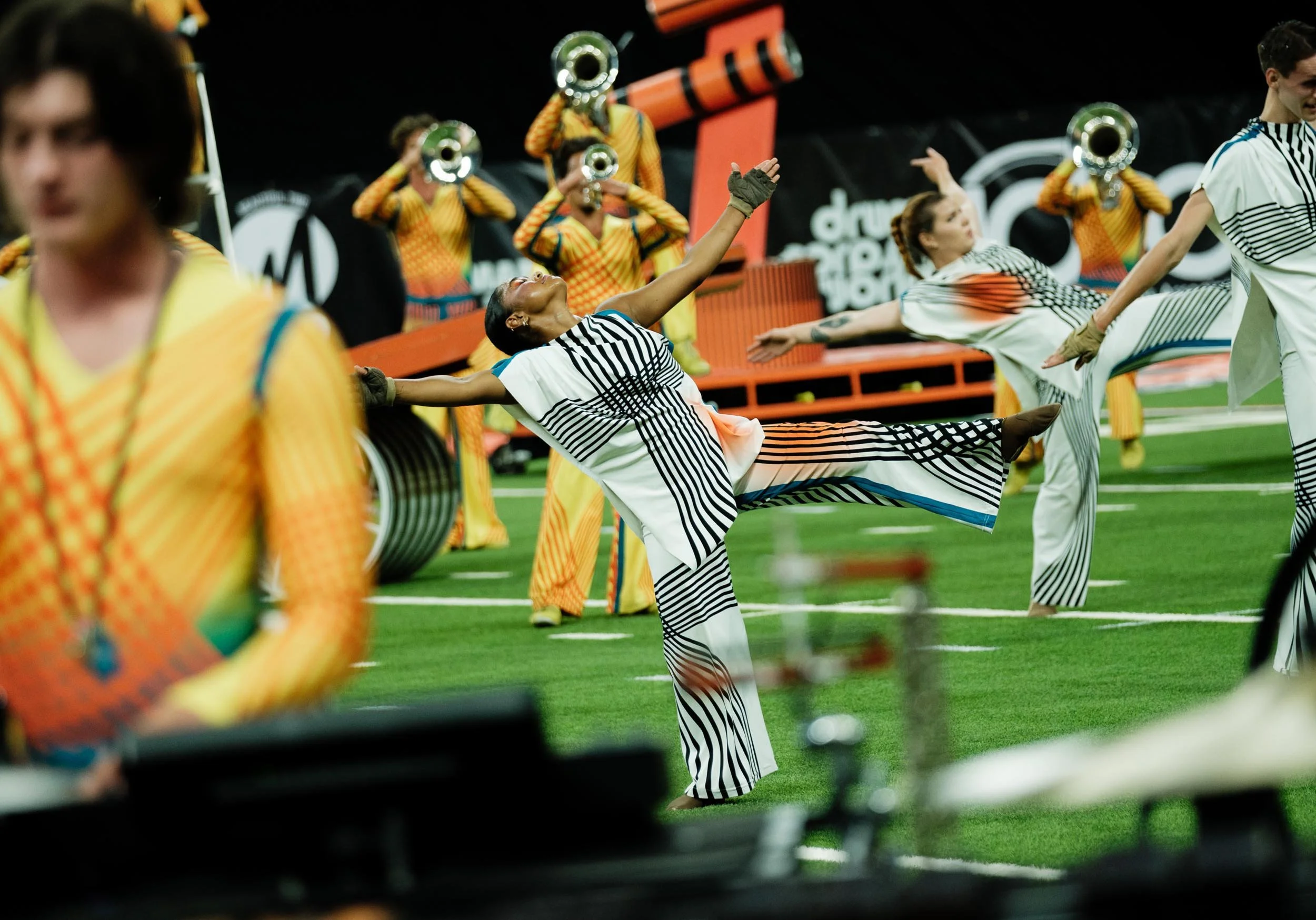Action shot of Bluecoats performers smiling.