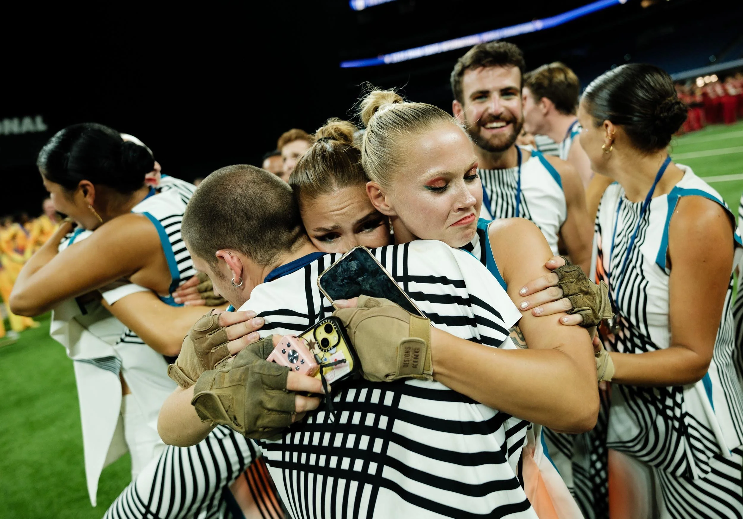 Photo of performers hugging.