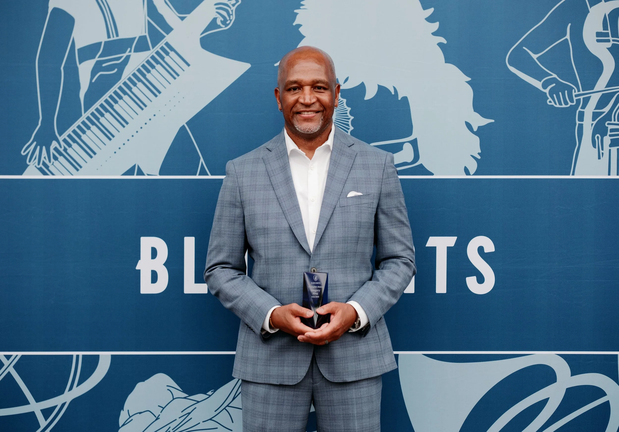 Photo of Gregory L. King in front of a Bluecoats backdrop.