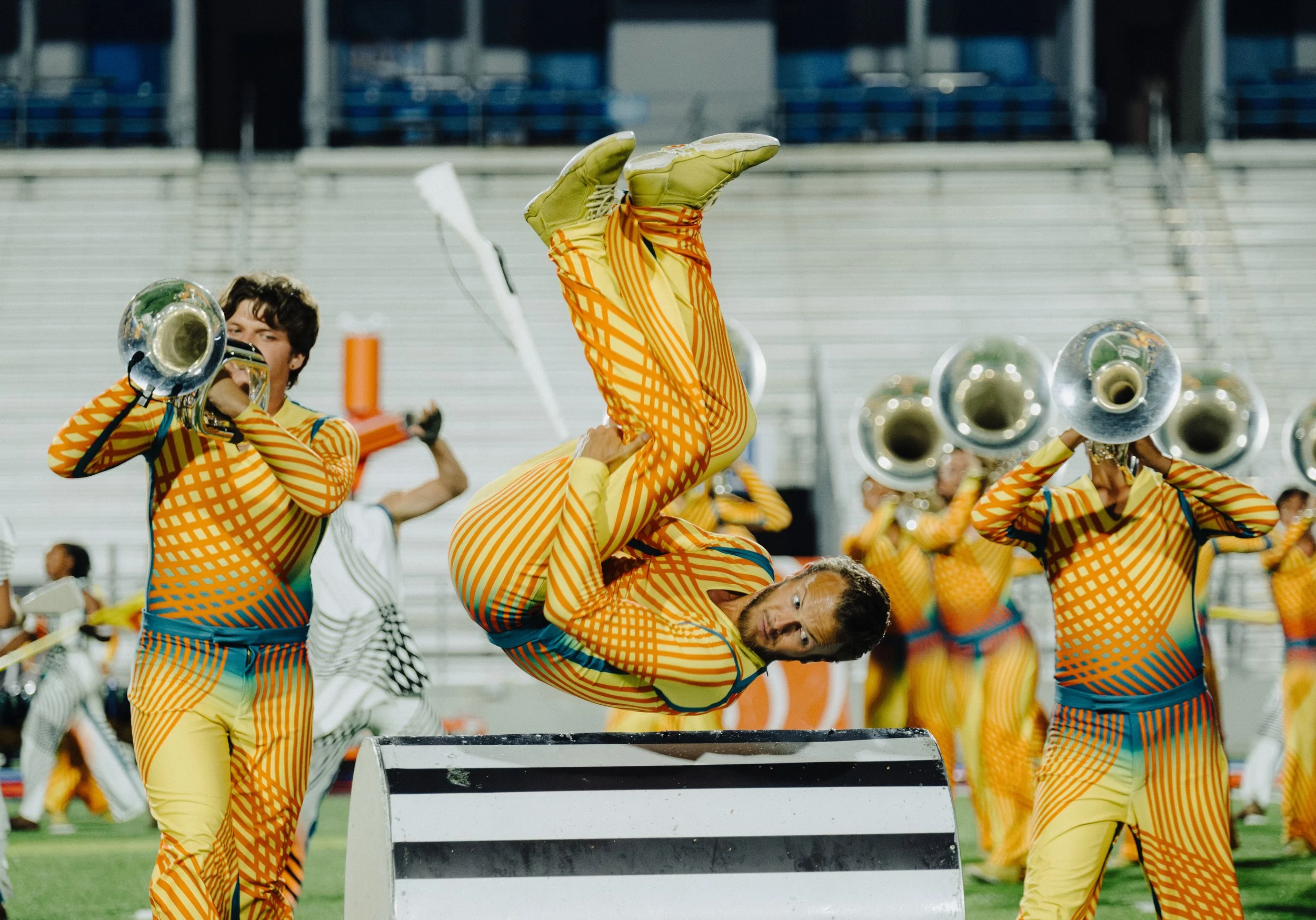 Action shot of performer flipping over a set piece.