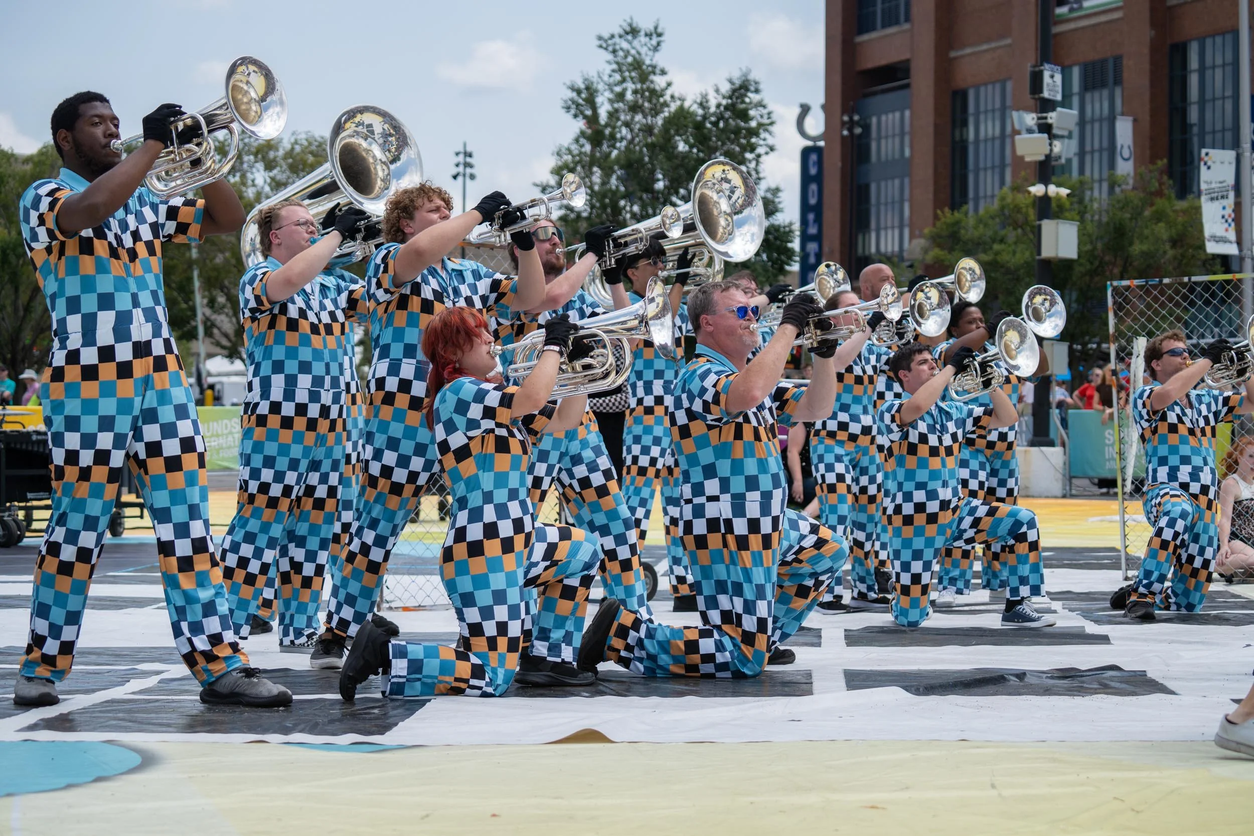Action shot of Rhythm IN BLUE brass performers.