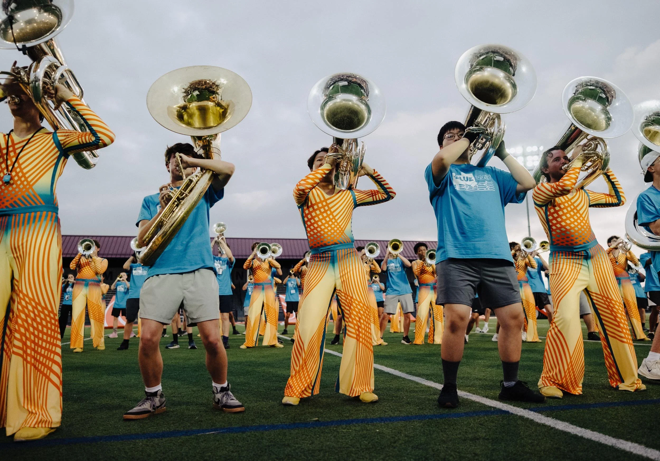 Photo of The Blue Way Summer Arts Camp students alongside The Bluecoats performers.