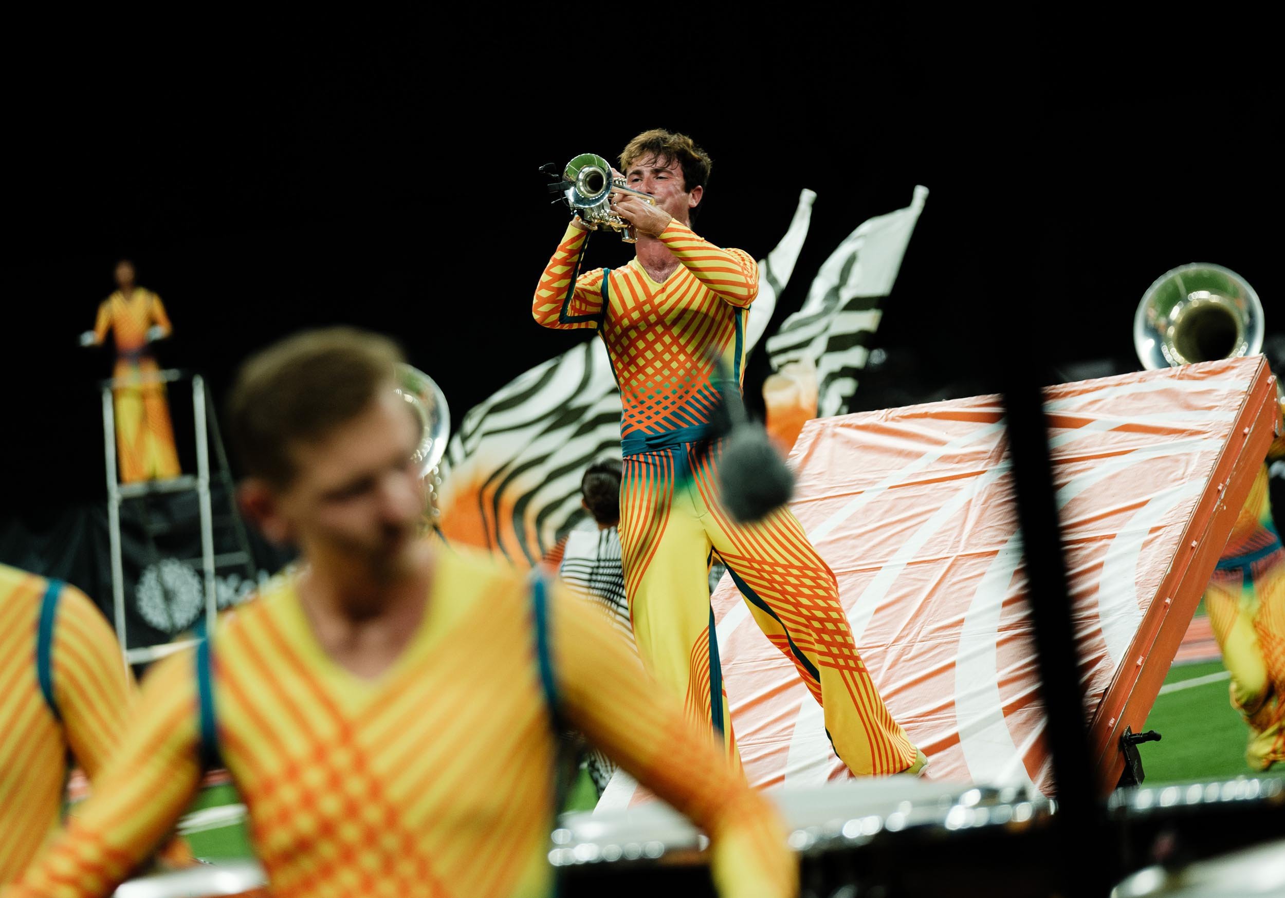 Action shot of Bluecoats performer playing trumpet.