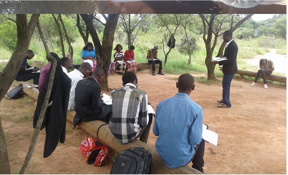  Pastor Boyd lectures in open air.  Zambian health authorities require meetings to be in small groups in open air. Ndola (Copperbelt). 