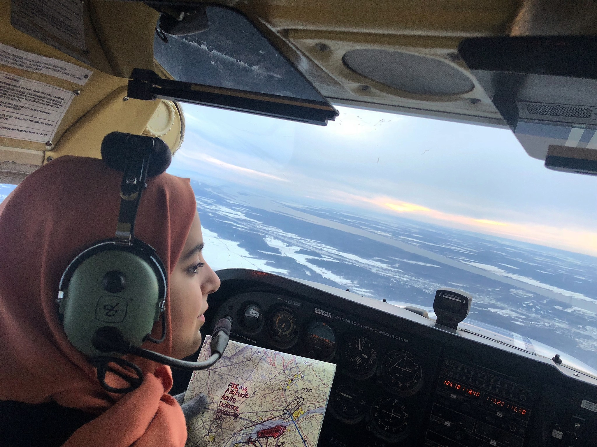 HQ photo of Nour Utayim in cockpit with map.png