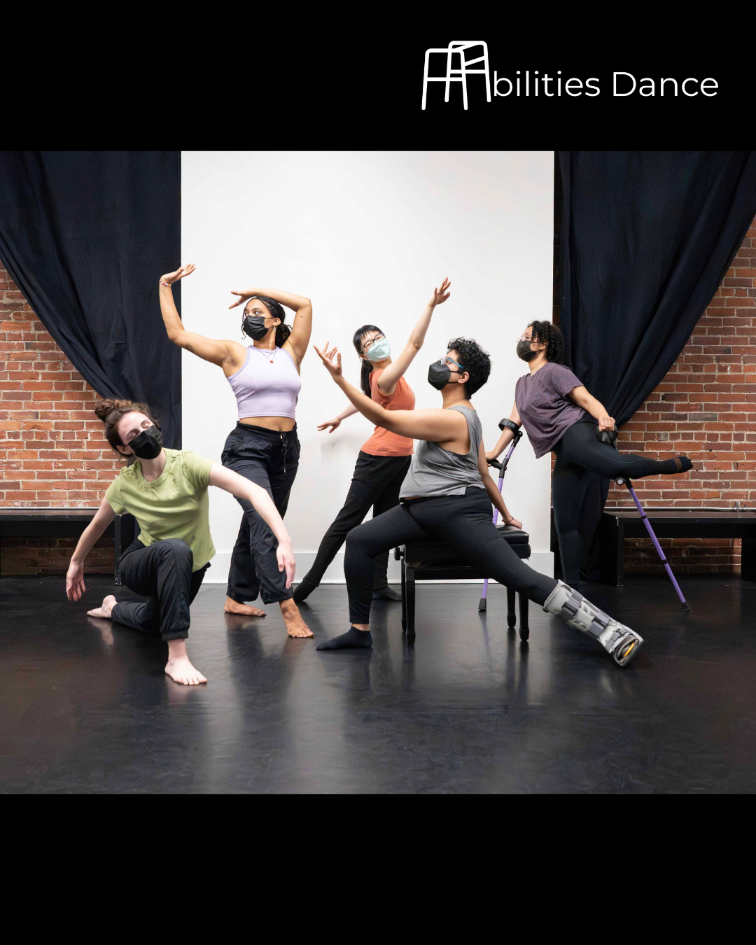  2026 Intersections v5 dancers wearing different colored plain tops. Left to right Tori lunging on ground with arms arced down. Izzi standing with one arm bent overhead and the other arm bent at side. Linda reaching with arms on a diagonal and right 