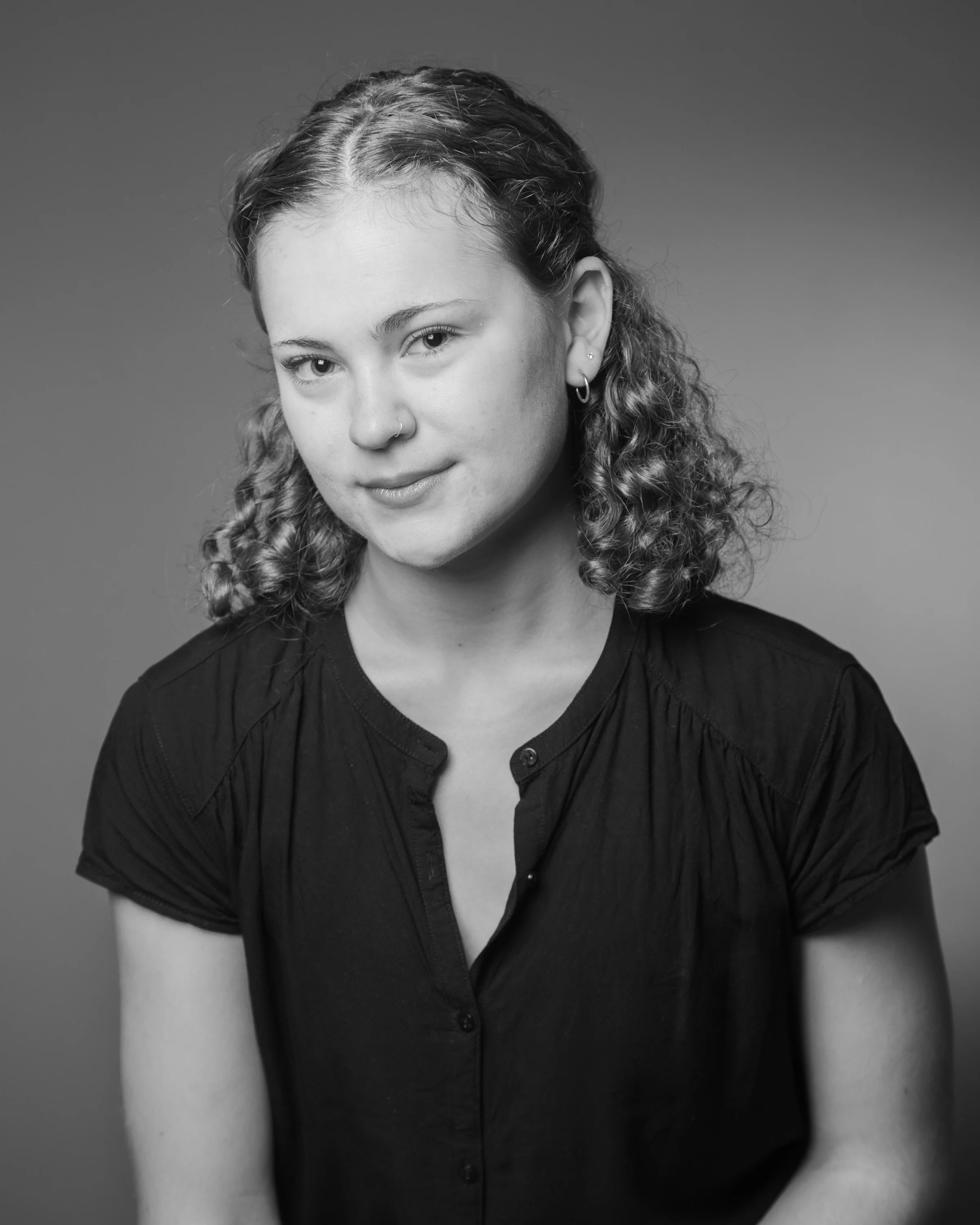 Black and white image of Sophie slightly smiling at camera