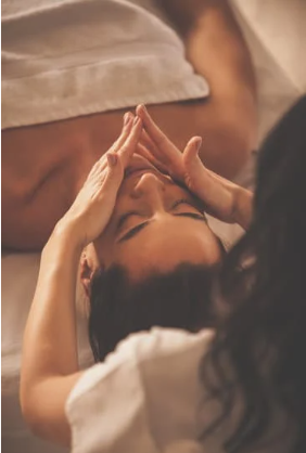 Woman laying on spa table getting a facial massage at Skin RNI in Canmore