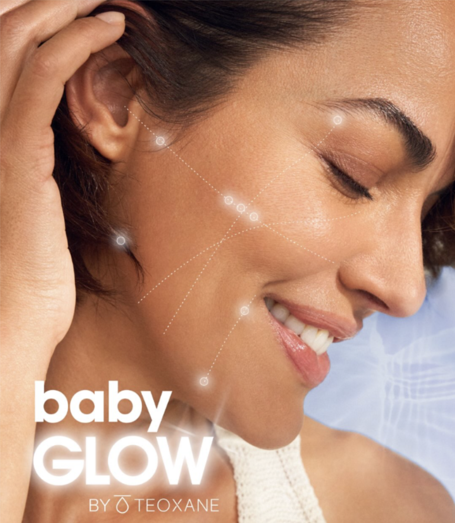 Close-up of a smiling woman with glowing skin, featuring graphic lines highlighting key areas of the face for Teoxane Baby Glow.
