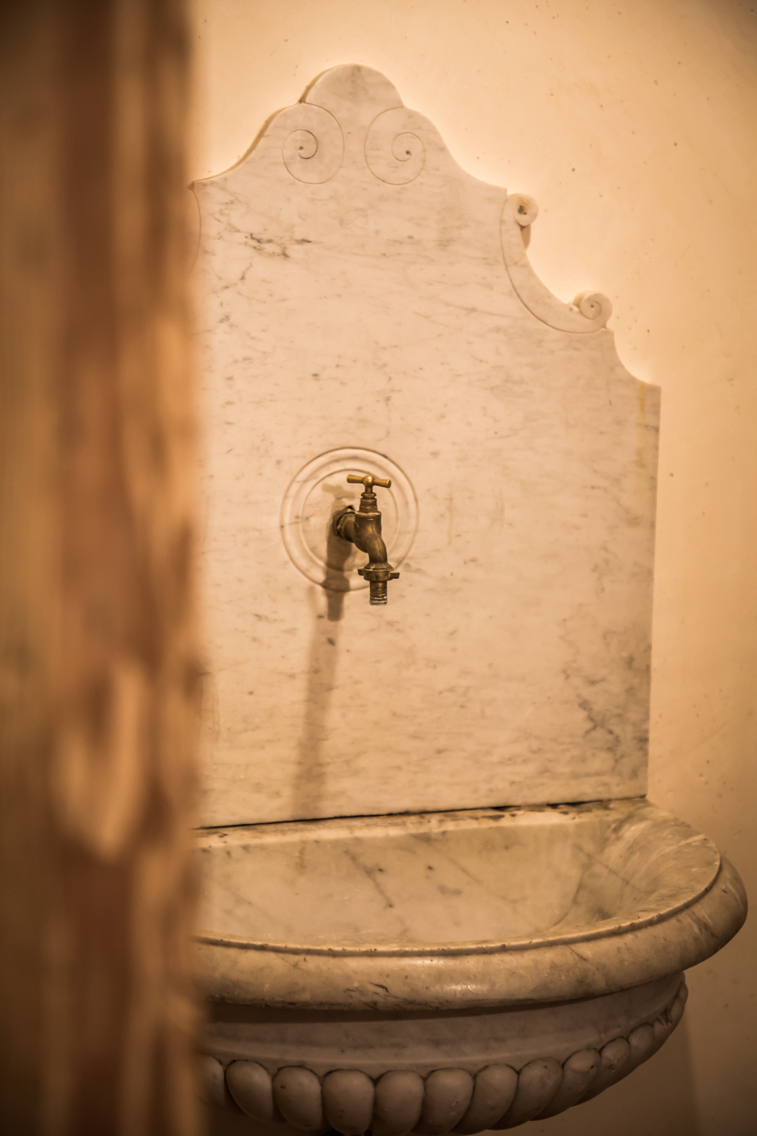 Detail of Italian Marble fountain now reclaimed and used in powder room at Chalet Forest