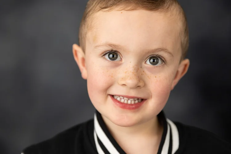 Close-up portrait of a child in a varsity jacket