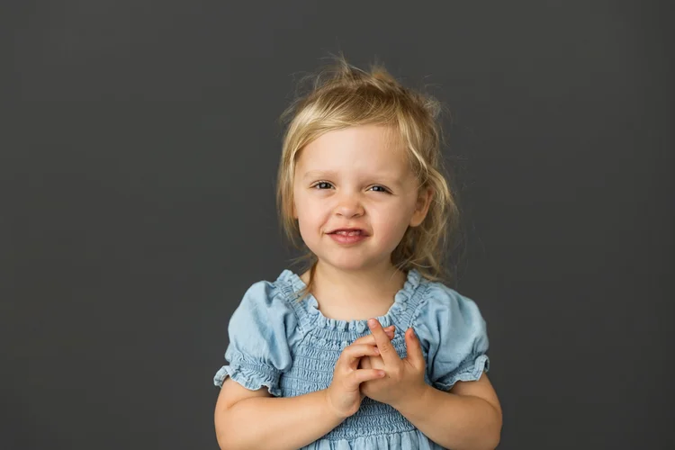 Child smiling in a blue dress
