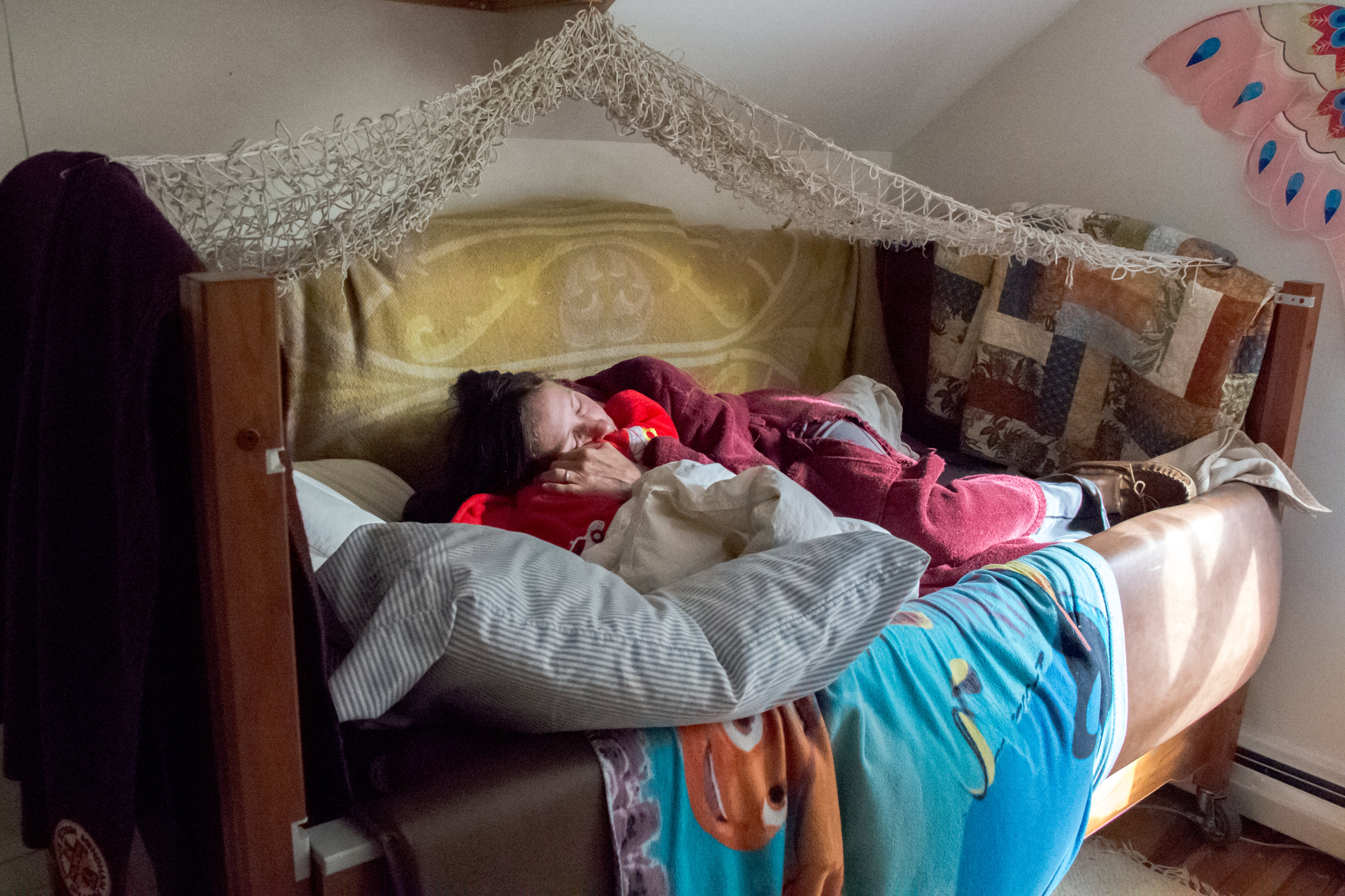  Christy Shake cuddles her son Calvin in his bed a few hours after he has had a grand mal seizure on September 30, 2017 in Brunswick, Maine. Though his number of daytime seizures has decreased dramatically since she began treating him with cannabis, 