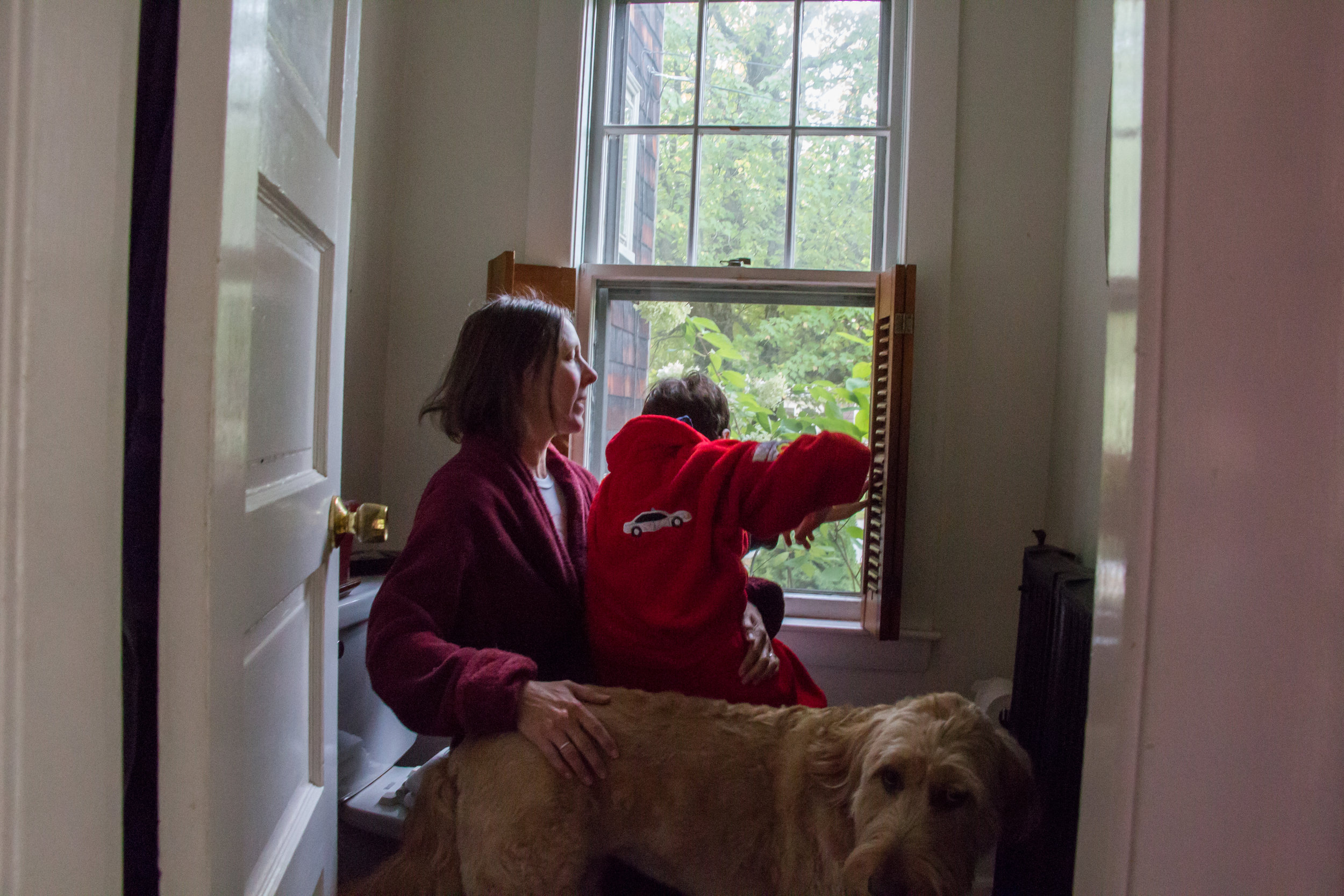  Christy Shake braces her son Calvin as he looks out the window of their home in Brunswick, Maine on September 30, 2017. Though Calvin can walk on his own now, his balance and vision are not good, and he can easily fall without Christy nearby to catc