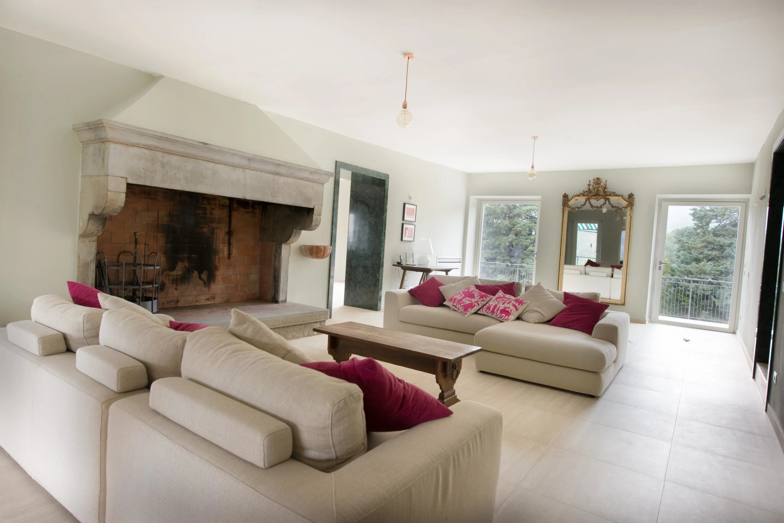  The villa is a treasure trove of beautiful antiques and restored architectural features such as the impressive living room fireplace. 
