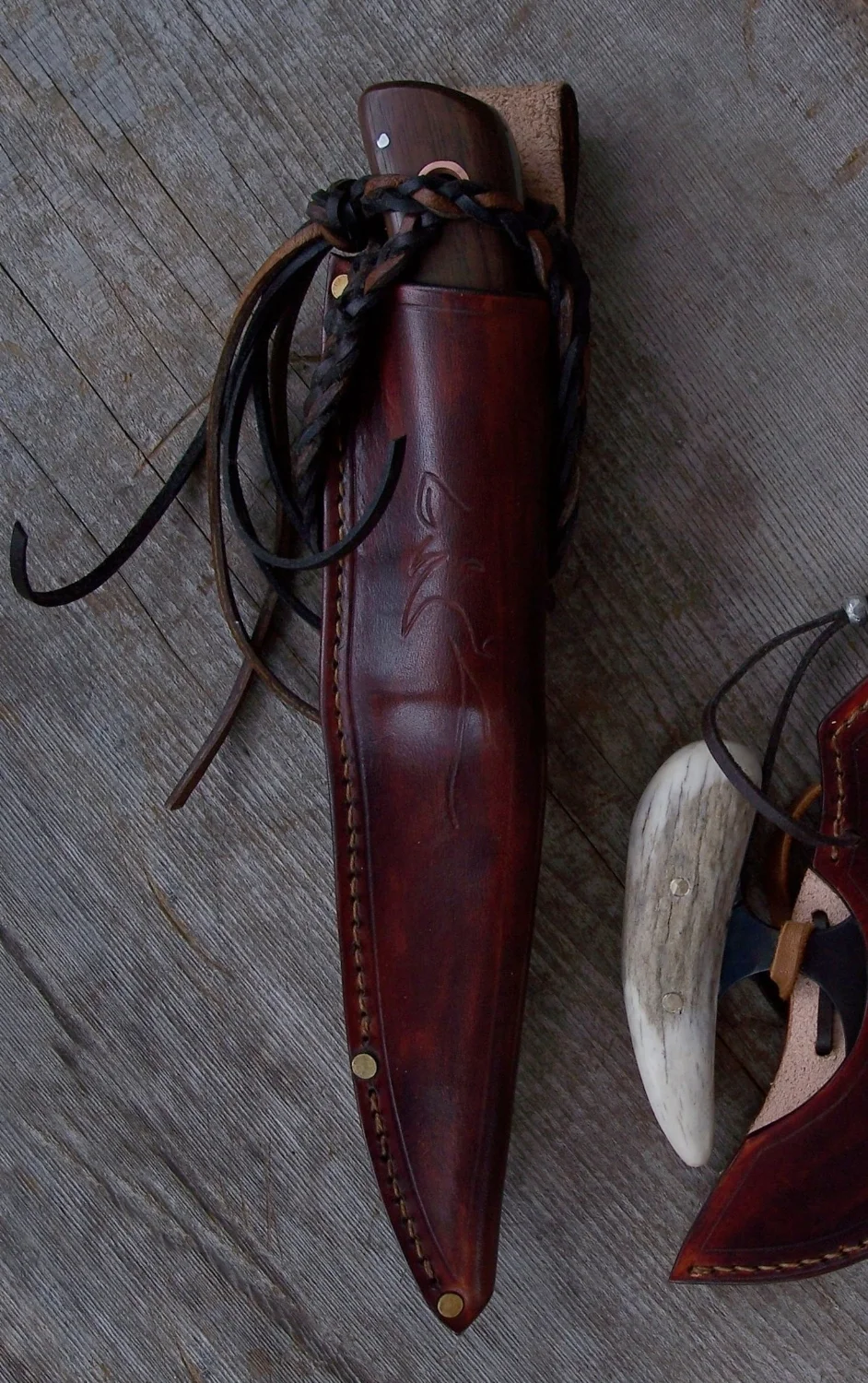 Long locking lanyard for knife security on the Kootenay hunting knife sheath.