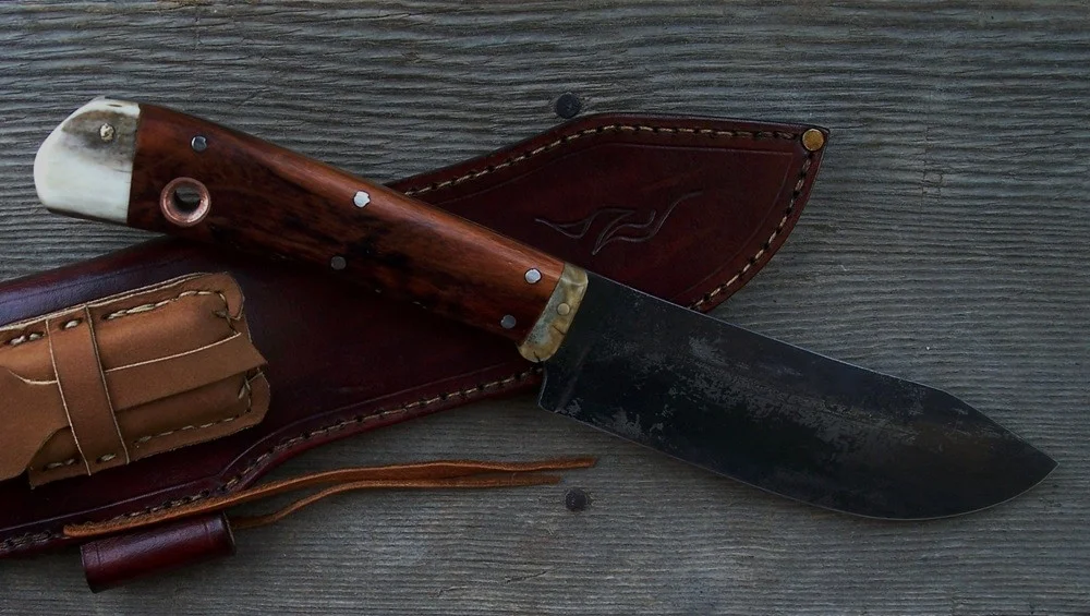 Handmade custom bushcraft knives with cherry wood heart scales, Moose antler butt and bolster. Brass pins and a copper lanyard hole insert.