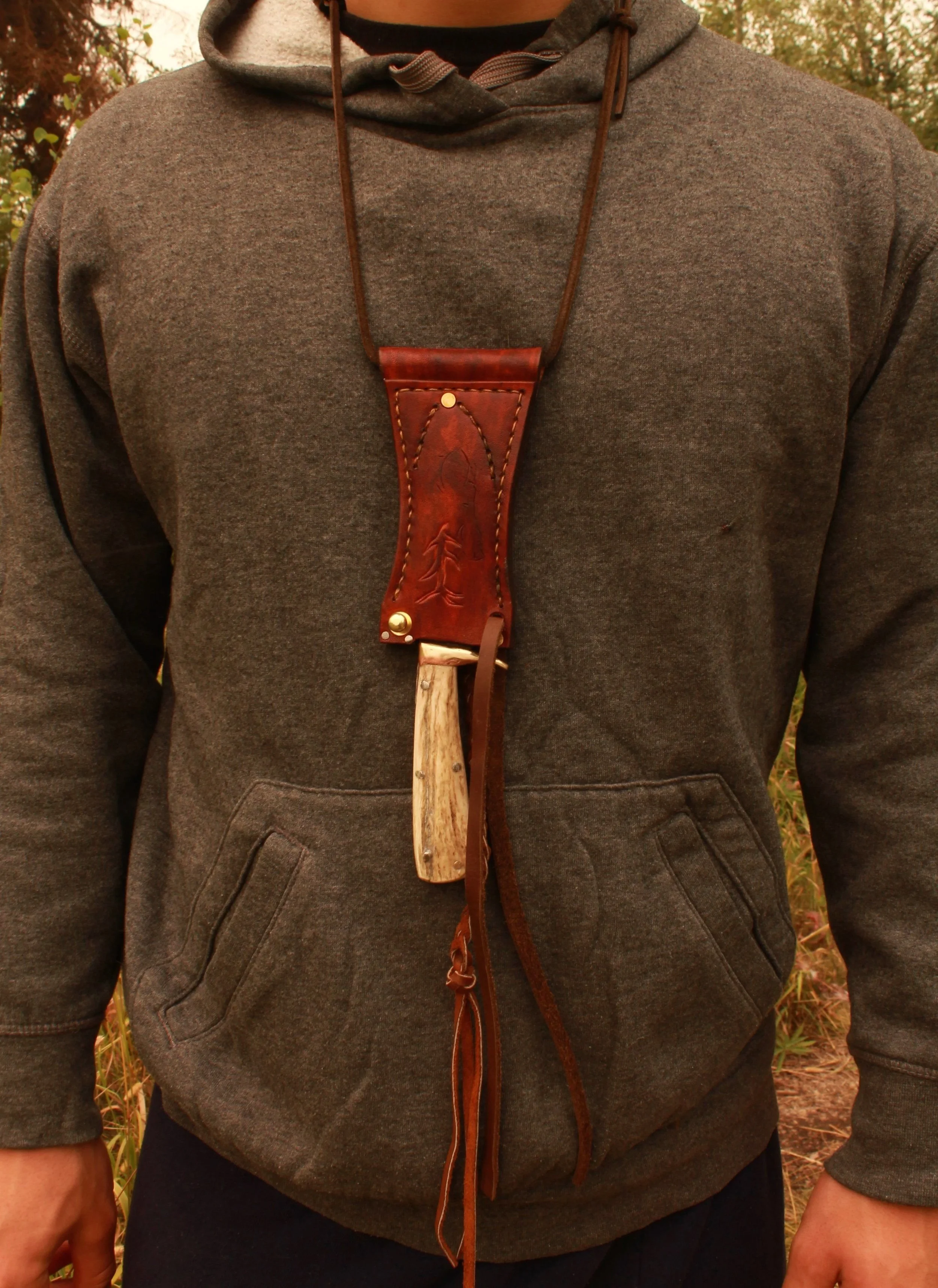 Exact and meticulously custom fit in its sheath . The Boar neck knife