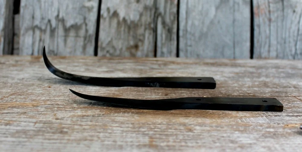 Custom hooks. The crooked knife blades are hand forged from lumber mill high carbon saw blades.