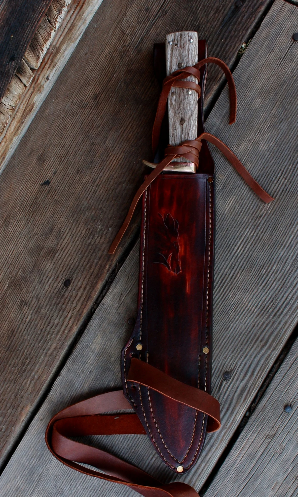 A hand forged 10 inch edge Boar survival knife with leather tie security. We double stitch all of our bush craft and survival sheaths now.