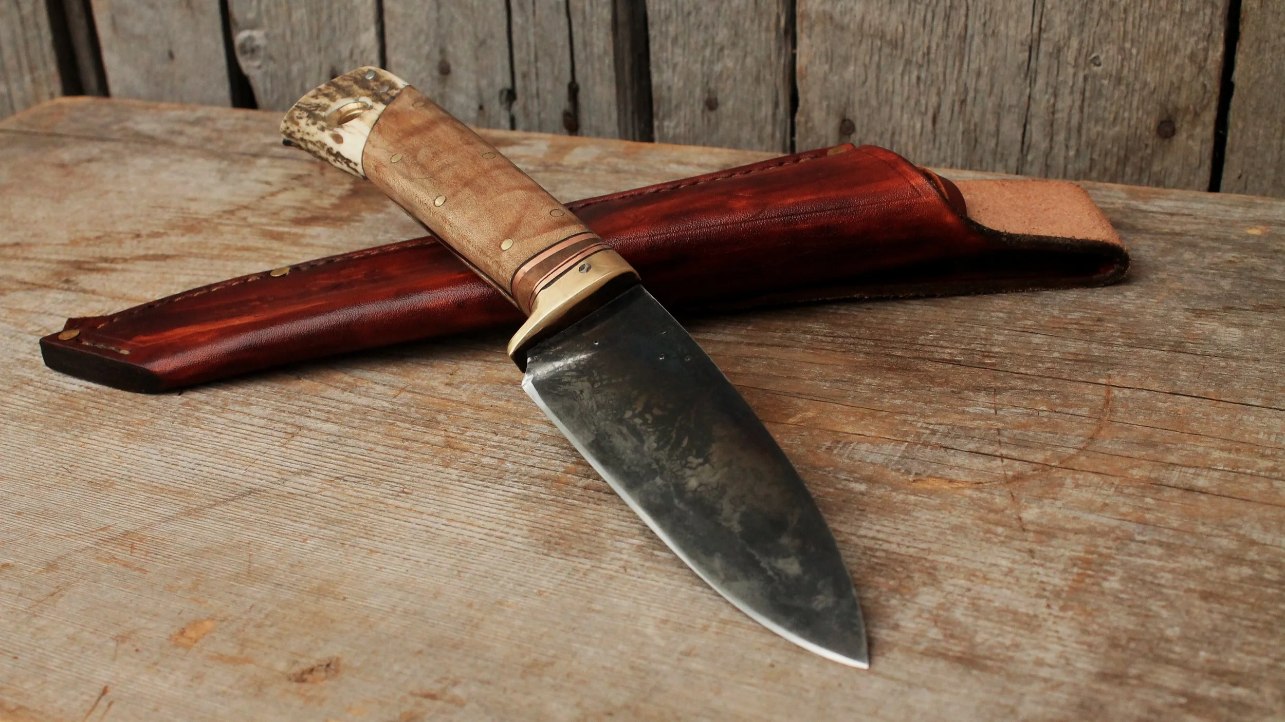 Custom hand forged hunting knife. Long handle, thick spine, high carbon lumber mill saw blade steel. A tough, strong handmade knife.