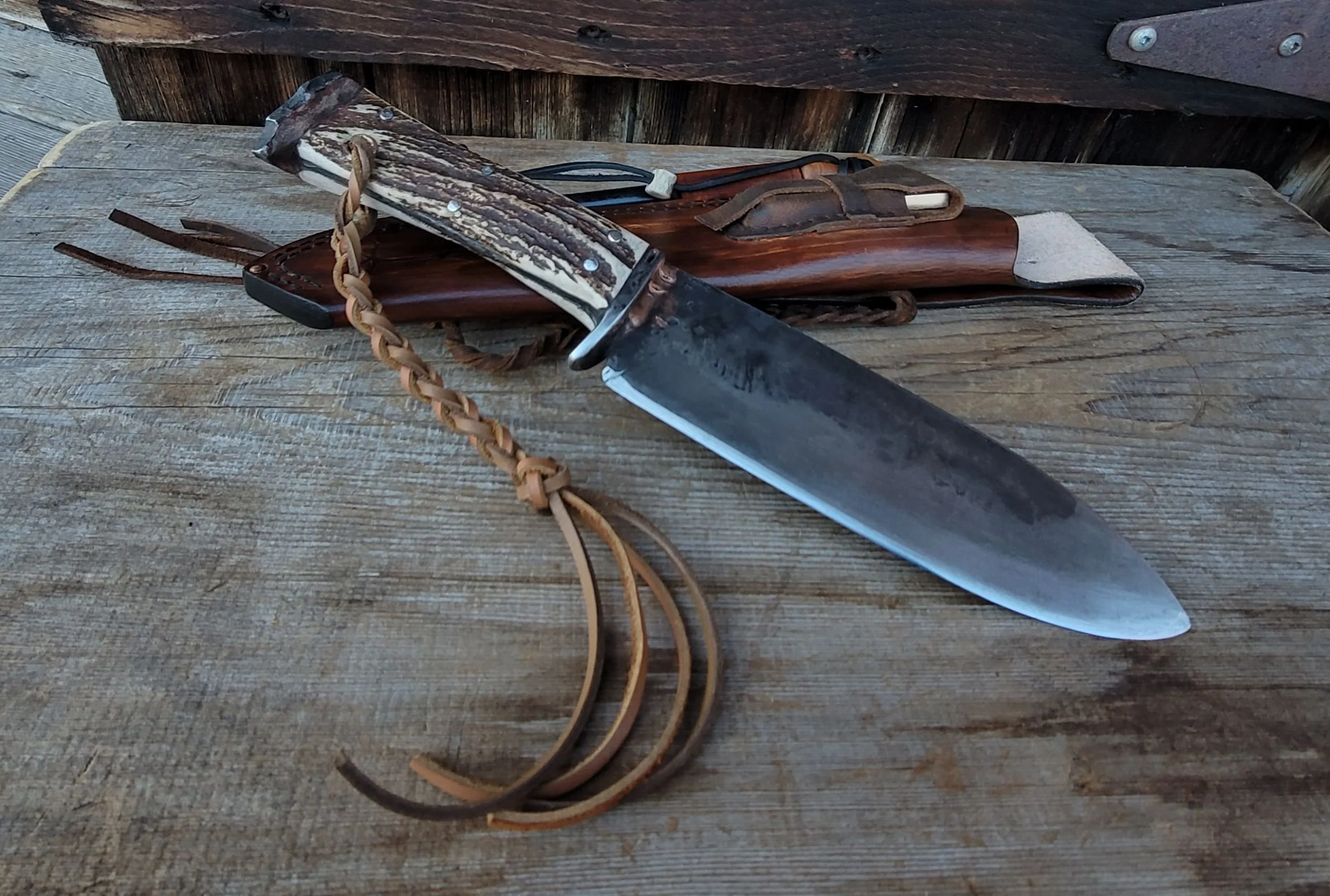 Mt. Caribou Survival Knife


Fire steel with a yew wood handle sits in loop cinched with an antler bead. Double sided diamond touch up stone in a pouch. Locking lanyards for securing the knife in its sheath.