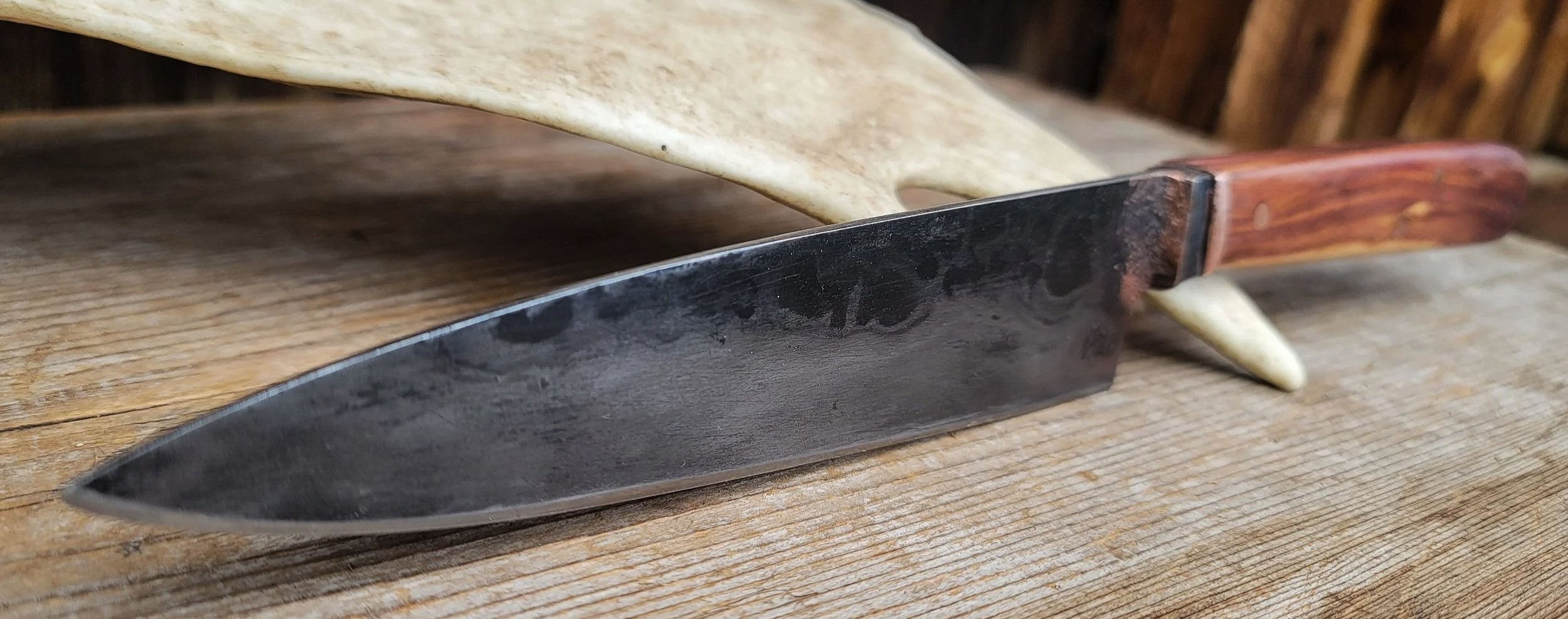 slicing gyoto with a forged carbon steel blade, copper, juniper wood handle