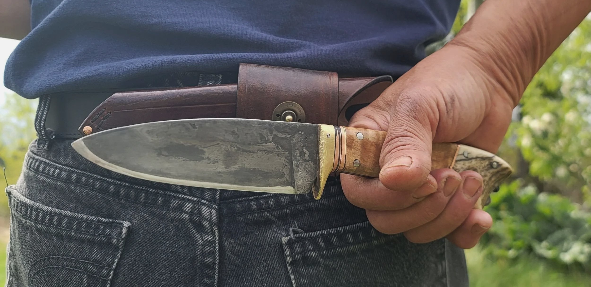 Heavy duty bushcraft knife with a scout style sheath