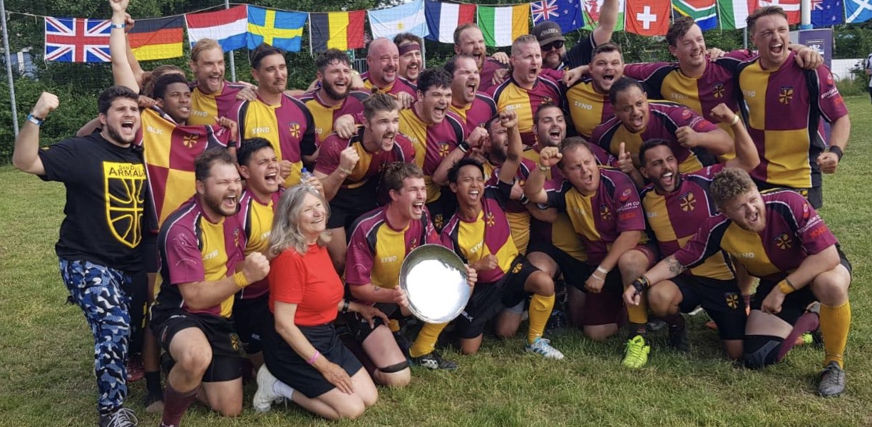 The post game presentation of the Bingham Plate in Amsterdam, 2018. The woman kneeling on the left is Alice Hoagland, Mark Bingham’s mother. We would later be formally presented with it at the closing ceremony (top of page).