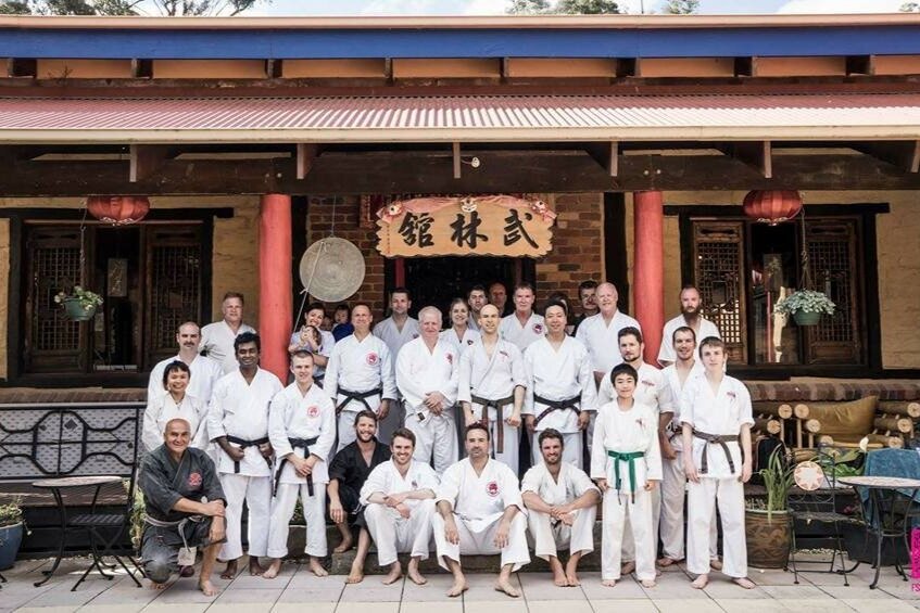 A group of karate experts and practitioners pose for a photo at Wu Lin Wellness Retreat after practicing goju ryu karate