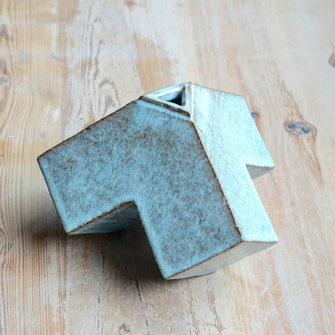 A new design I have been working on. Tripod vessel, hand built out of some very groggy and dark clay. 

The second photos is showing the vessel sitting on three square points. The next one shows the symmetry of the vessel.

Available at Suffolk craft