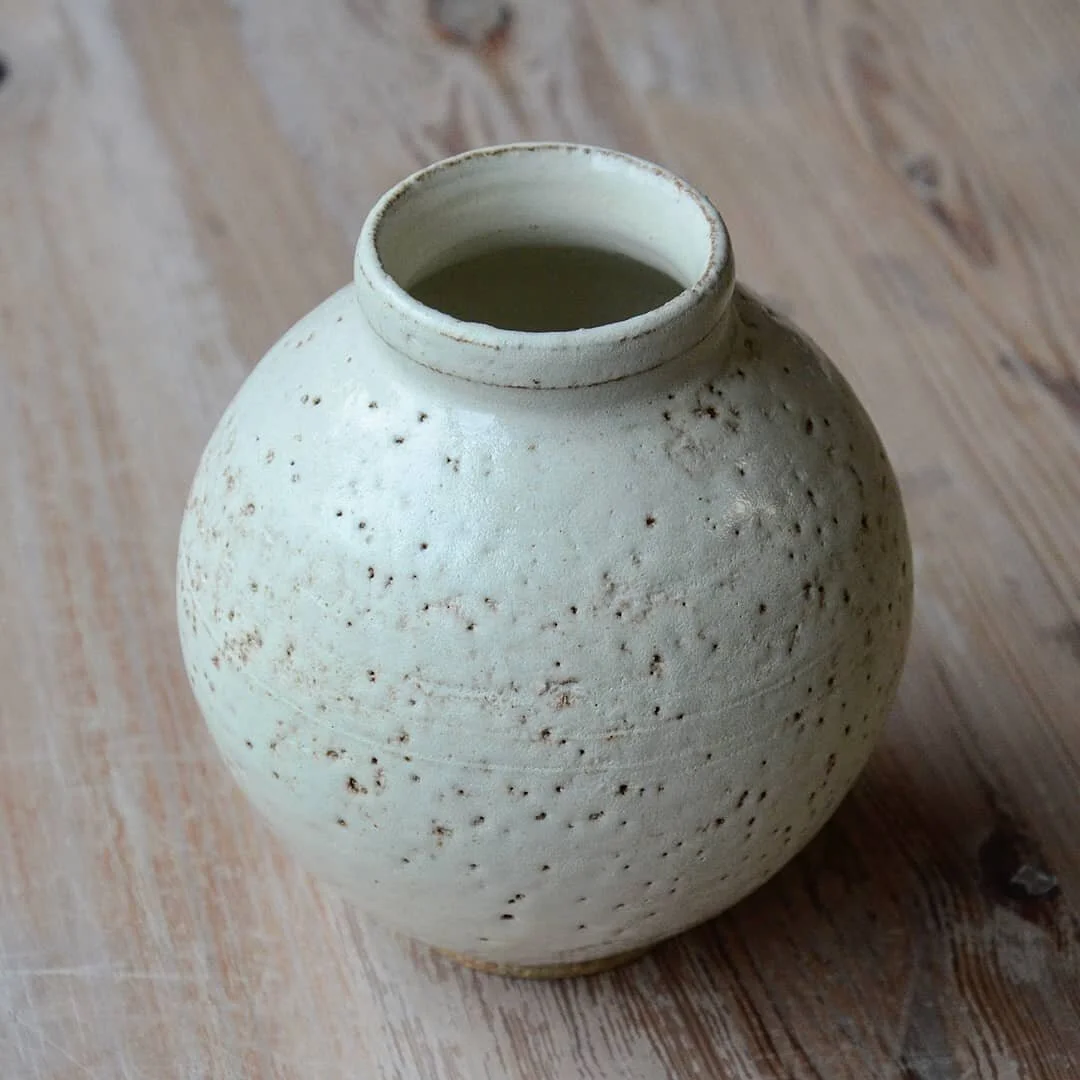 Small creamy groggy moon jar. Throwing very stoney clay it a bit hard on the hands, I use thick slip instead of water to center, lift and shape these jars. I find doing this protects my hands a bit more. 

I have Wednesday Evening and Saturday mornin