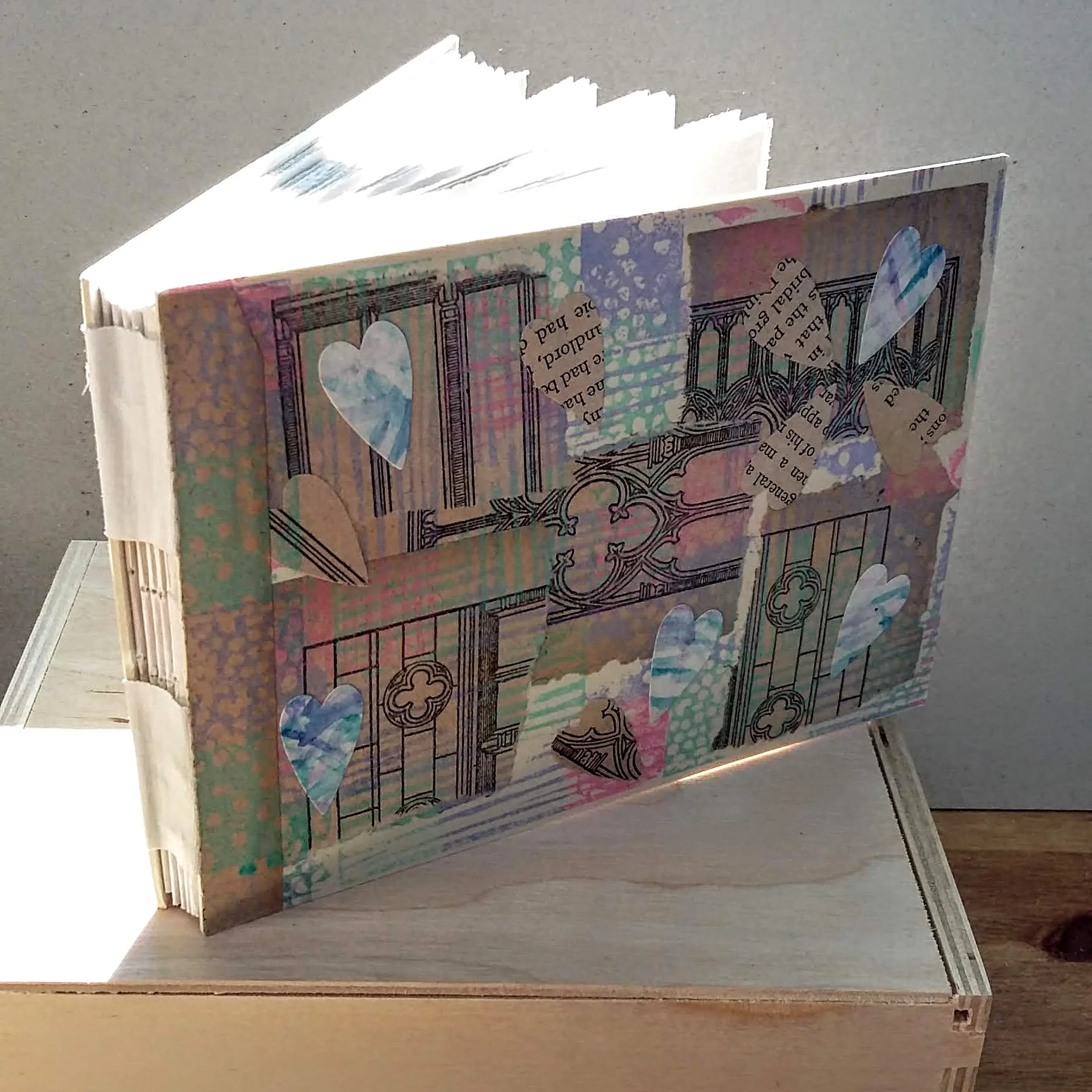 SOLD Hearts landscape book, paper collage A6 size. 15.5 x 11 cm. 92 sides, 46 pages.