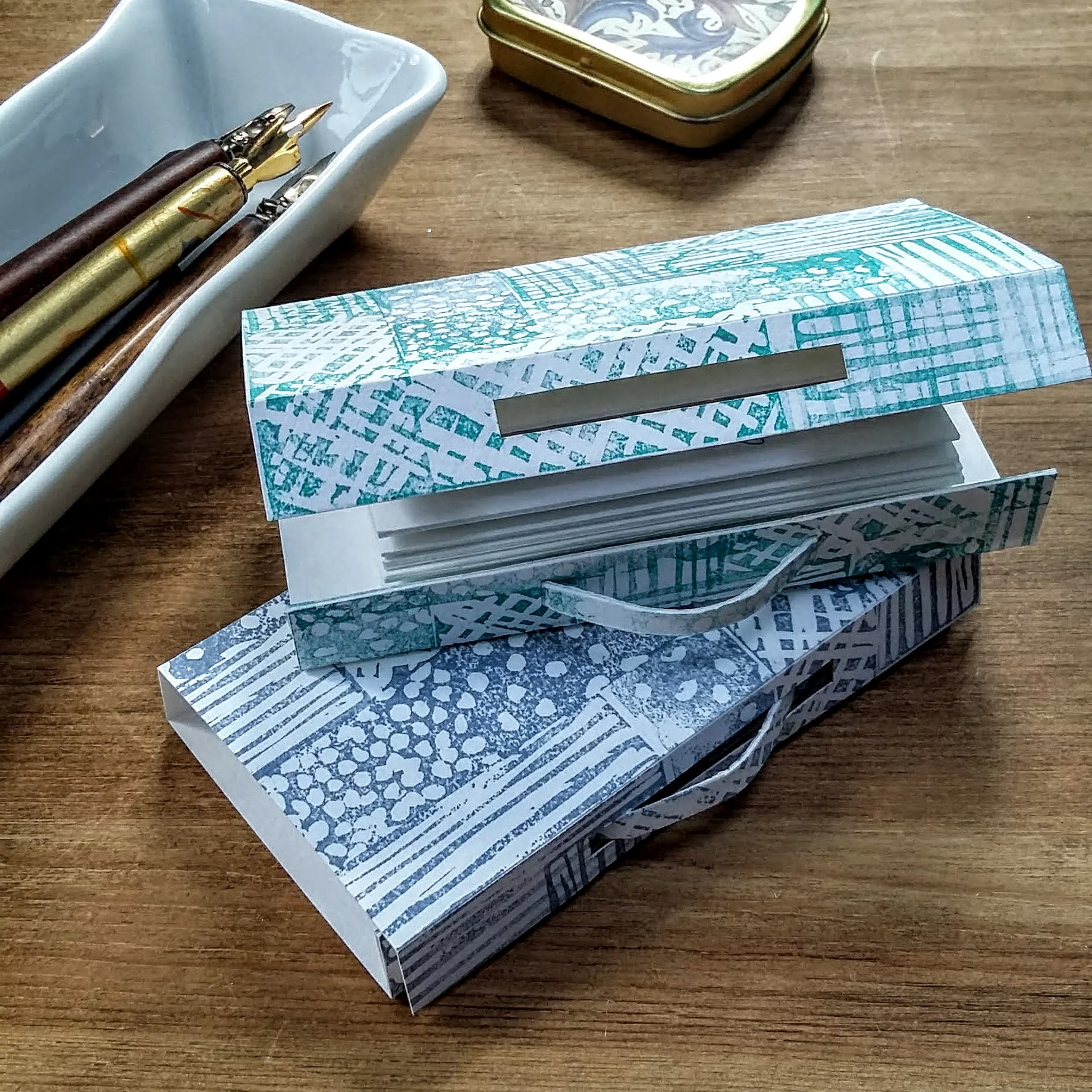 Suitcase Poem. 10.5 x 6 x 1.5 cm. Concertina folded into ‘suitcase’. £22 plus p&p. Green and grey available.