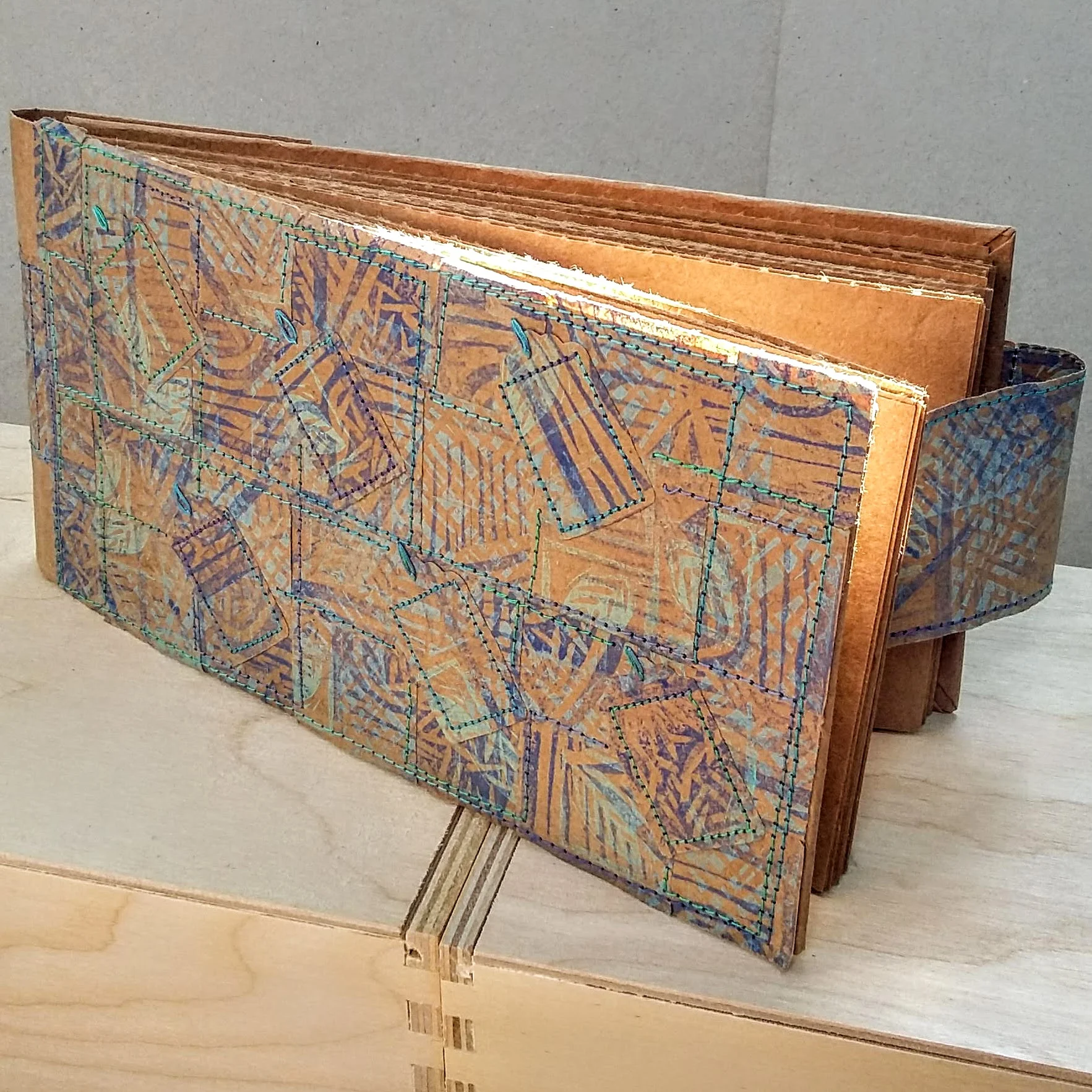 Recycled magnet closure. 20.5 x 11 cm. 92 sides 46 pages of recycled packaging. £32.50 plus p&p