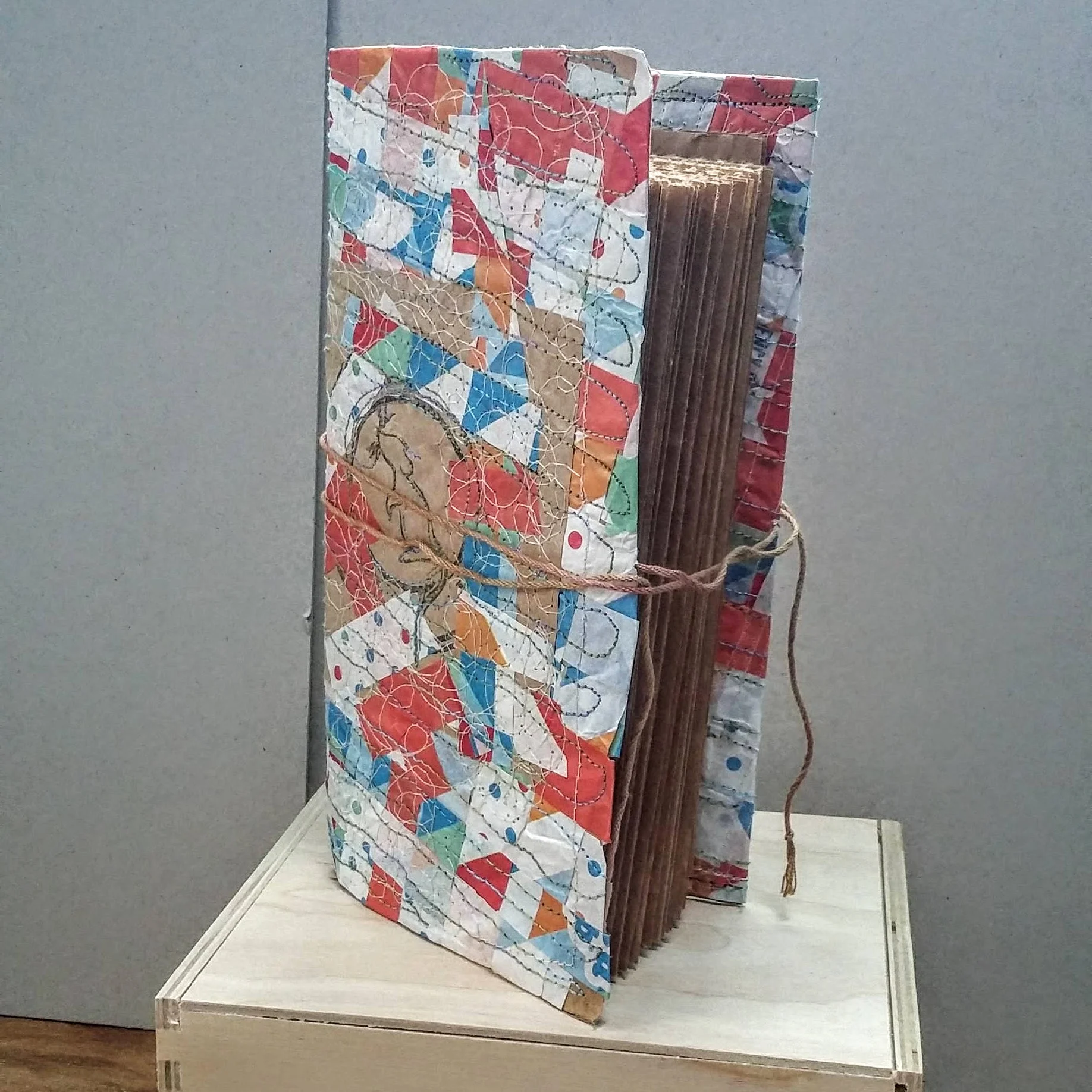 Recycled ‘mouse’ book with folder flap inside back cover. 11 x 21 cm. 96 sides 48 pages of recycled packaging. £37.00 plus p&p