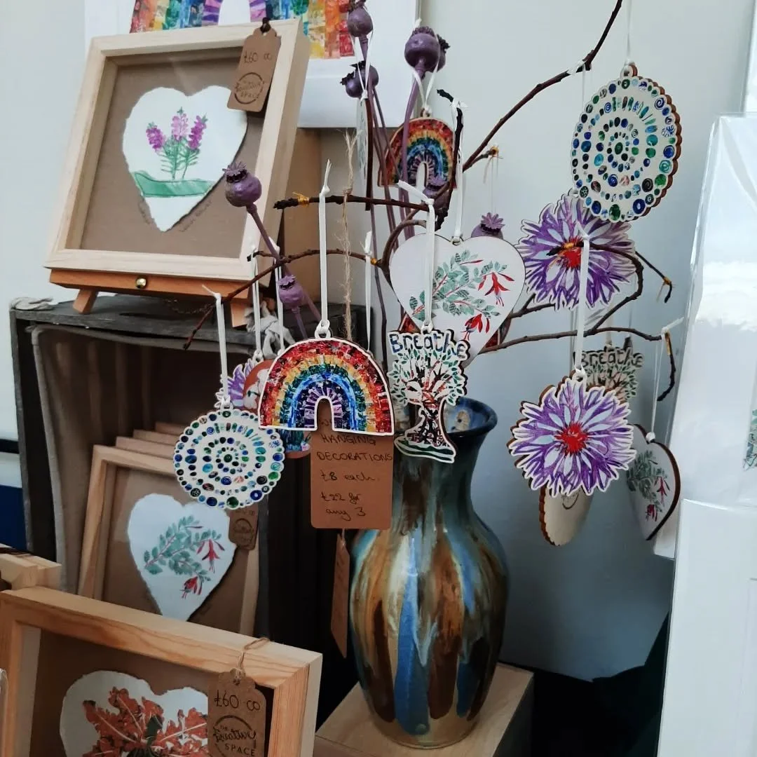 All set up and ready to go for @bostonspaartscraftsfestival tomorrow and Sunday. 
I've got my lovely new #WoodenDecorations on display, with some of the original artworks that the designs came from. 
Many thanks to @lightning.laser for the beautiful 
