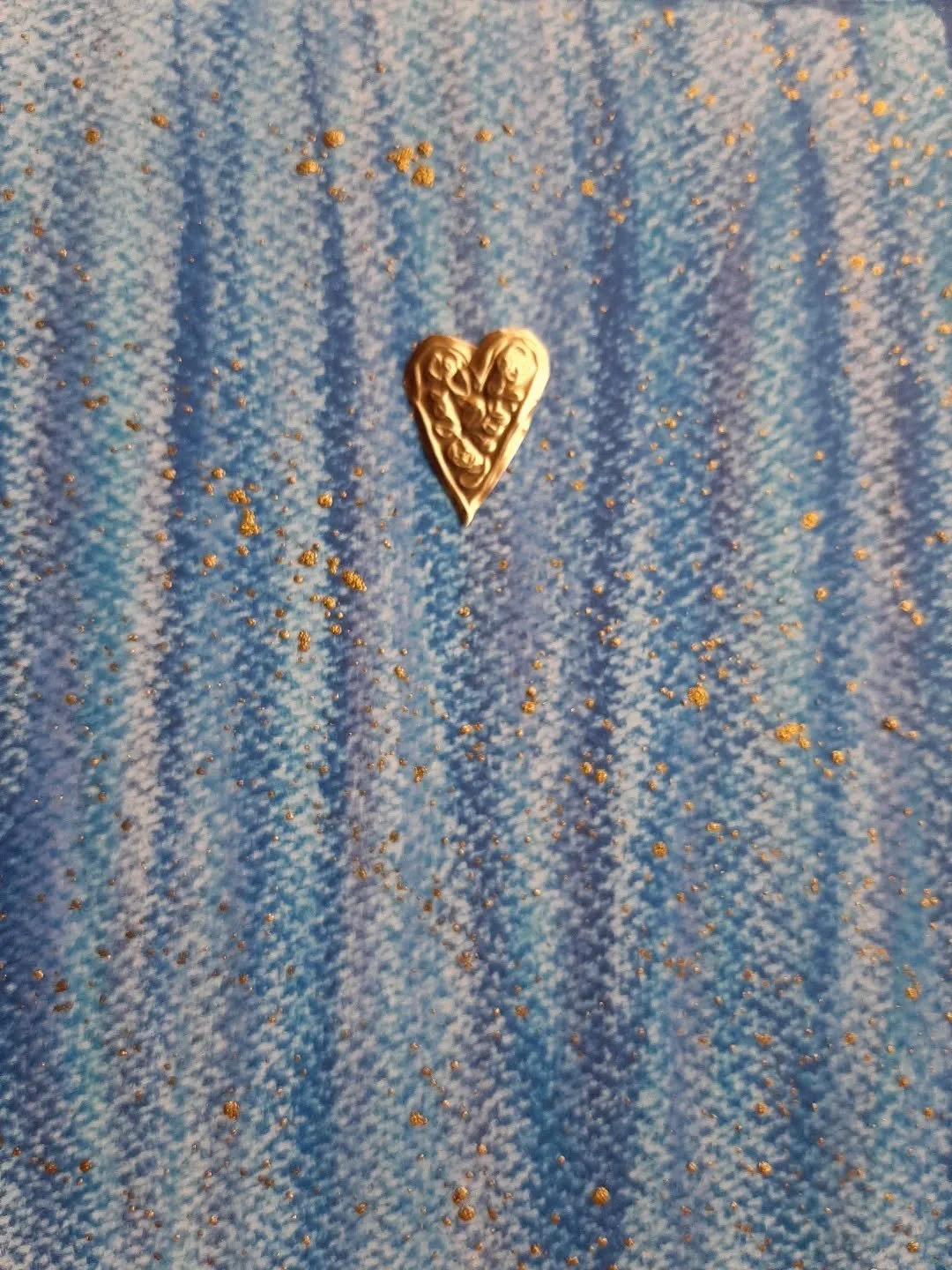 Something's coming with these beautiful colours 😍 
I think (did this a while ago!) the blues and purples are oil pastels on watercolour paper. 
Then splattered with gold ink. 
The heart is a tiny embossed foil.
I'm working on a quote from #ThichNhat