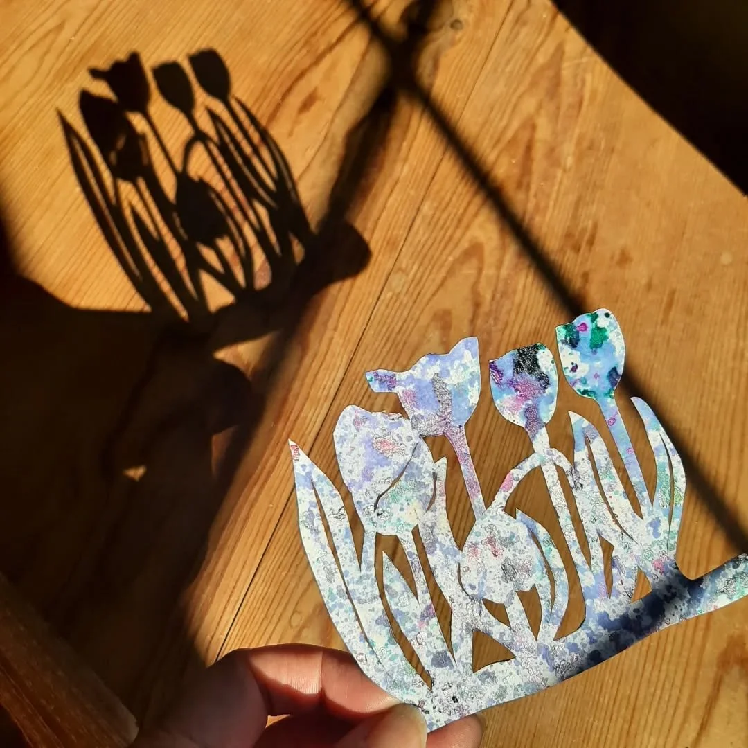 Good morning sunshine 🌞 
Hello shadows! 
Showing off my new #Tulips paper cut in the morning sun.
Cut from one piece of painted paper. This is deli paper applied onto a piece of cartridge paper. 
I draw the design on the back before cutting it out w