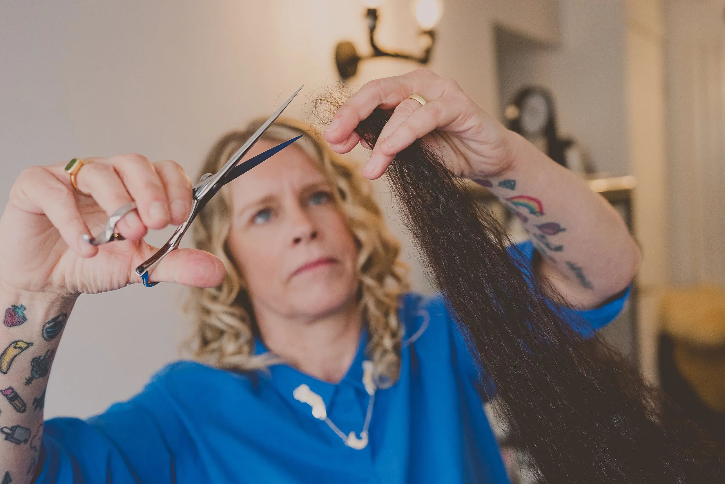 Lindsey cutting a client's curly hair in her Rugeley studio