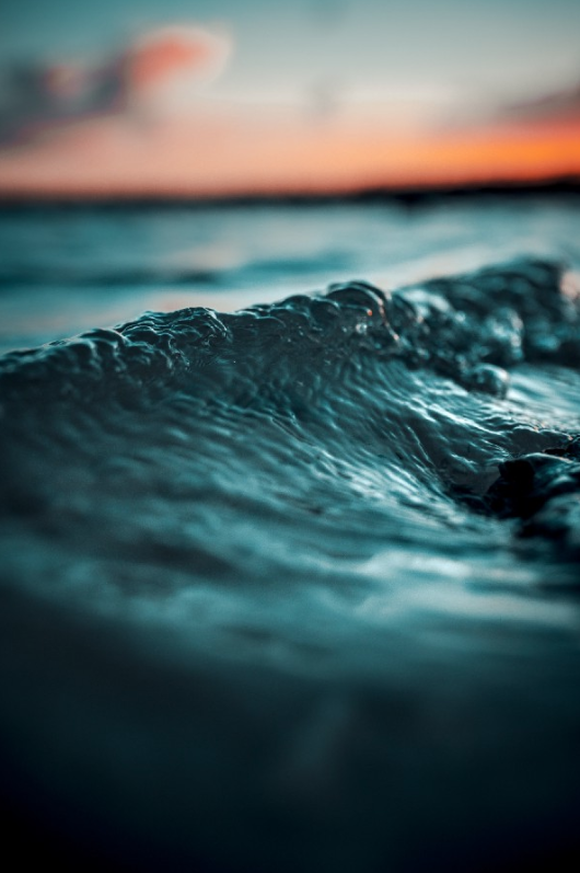 “selective focus photo of water wave” by Alex Perez on Unsplash