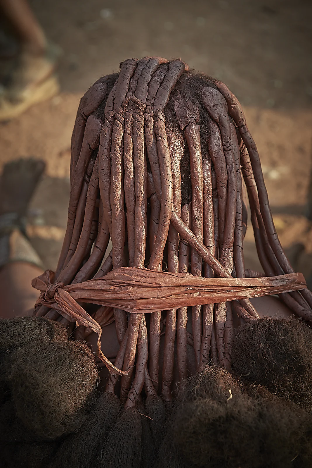 women coat their hair with a mixture of butter fat, earth and ochre powder, in thick locks. because of the dryness of their environment, these dry very quickly and become brittle, which is why one of the main daily tasks of any woman is to apply a new coat of fat and ochre on her hair!