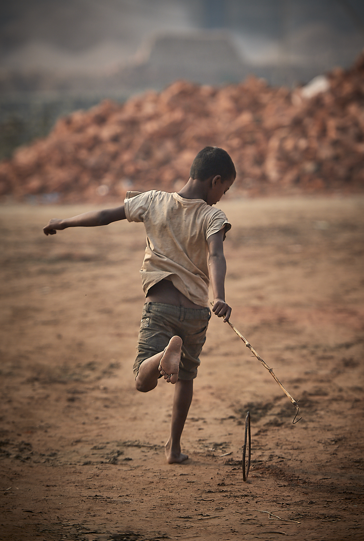 child playing among the stacked bricks