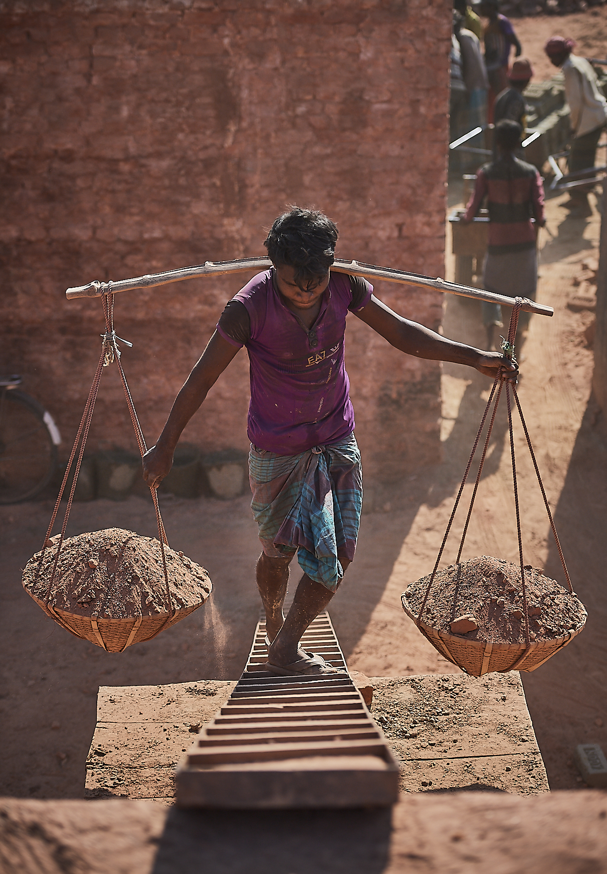 collected sand is carried to the top of the bricks